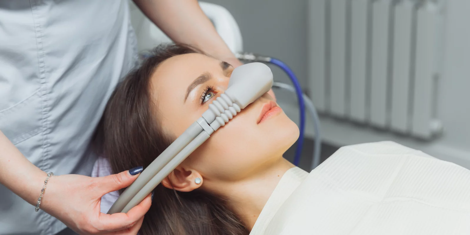 dentist puts inhalation sedative mask on his patient.